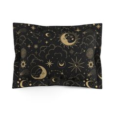 a black and gold pillow case with stars, moon and clouds in the night sky