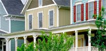 a row of houses with red shutters and green trees