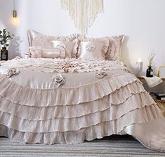 a bed with ruffled bedspread and pillows