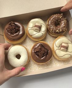 a box filled with donuts covered in frosting