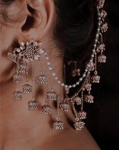 a close up of a woman's ear with earrings on her neck and back