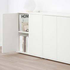 a white cabinet with books and magazines in it