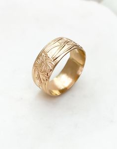 One of our most-loved rings ~ Marigold is a cigar band ring with a vintage floral design. Add this charming piece to your collection to stack or make a statement. * Recommended to order 1/2 size up from your normal ring size. This band tends to fit tight. ﻿Band width: 8 mm // Band thickness: 0.5 mm Modeled with our bold rope ring Handmade to order in high-quality 14k gold fill to withstand daily wear time after time.