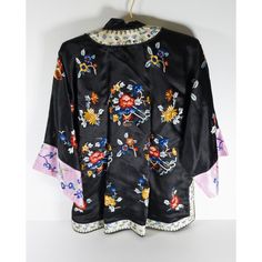 We are selling this Chinese 20th century silk embroidered jacket. The jacket has black ground color with floral motifs and pink sleeves. The jacket is small in size and probably a ladies or child size.  Condition: Good vintage condition.  Dimensions: Height 28 1/2 Inches 72.4 cm Chest Width 20 1/2 Inches 52.1 cm Width at Sleeves 48 Inches 122.0 cm Traditional Silk Outerwear For Spring, Spring Silk Kimono With Floral Embroidery, Black Silk Outerwear For Spring, Vintage Black Kimono For Spring, Spring Silk Kimono With Embroidery, Spring Embroidered Silk Kimono, Black Silk Kimono For Spring, Chinese Chinoiserie, Black Ground