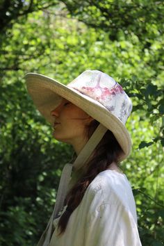 "This 'Anna' hat is one of my best sellers the shape is very flattering and offers really good protection from the sun, while creating a simple elegance in the overall look of the hat. Made from beautiful watercolour flower natural linen, with a natural linen contrast.  With two natural linen ties to secure the hat on Windy days.  The ties are 1\" wide and 23\" long The brim width is 14cm at the front tapering to 10cm at the back to offer freedom of movement, and to help stop the hat catching at Natural Panama Hat For Spring Outdoor, Lightweight Wide Brim Hat With Uv Protection, Natural Panama Hat For Spring Outdoor Activities, Spring Outdoor Panama Hat In Natural Color, Natural Bucket Hat For Spring Outdoor, Spring Bucket Hat With Uv Protection In Natural Color, Spring Natural Color Bucket Hat For Outdoor, Bohemian Adjustable Sun Hat For Garden Party, Adjustable Bohemian Sun Hat For Garden Party