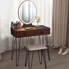 a dressing table with a mirror, stool and shoes on the floor next to it