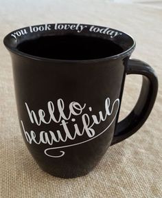 a black coffee mug with the words hello beautiful written on it's side, and you look lovely today