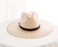 Hats are sized at 58cm (large) and include an adjustable inner, cotton sweatband for a more comfortable fit. Each hat comes with a genuine brown leather hatband.

Each handmade hat is unique and may have small imperfections or vary in size and color. All Leah products are responsibly sourced and ethically crafted. Brown Fedora With Flat Crown For Ranch, Brown Flat Crown Straw Hat For Vacation, Rustic Brown Fedora With Curved Brim, Brown Flat Crown Sun Hat For Beach, Brown Wide Brim Sun Hat For Everyday, Brown Straw Hat With Curved Brim, Everyday Brown Wide Brim Sun Hat, Western Style Brown Panama Hat With Flat Crown, Brown Panama Hat With Flat Brim