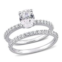 an engagement ring set with a white diamond in the center and side stones on each band