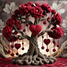 a knitted tree with red hearts hanging from it's branches and the words love is