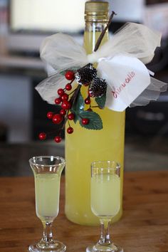 a bottle and two glasses on a table