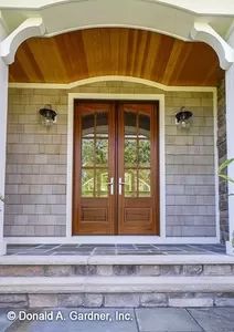 the front entrance to a house with two double doors