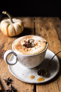 there is a cup of coffee with cinnamon on the saucer and star anise