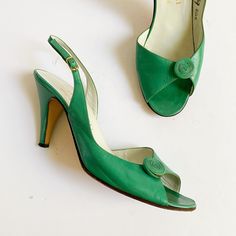 Vintage 1980s Studio Bruno Magli for Saks Fifth Avenue heels in an unusual shade of green. Rolled rosette detail at the open toes, slingback heels, and open at the inside arch. Made in Italy. Leather is in really nice condition - soft and supple with some creasing and scuffs to the heels. Some darker areas at the rosettes as shown.  Marked an 8.5N; I'm a 7-7.5 and there is space at the back. Please compare with a pair of your own shoes for reference. 10.25" along insole from toe to heel, 3" across ball of foot, 3.5" heel height. Sparkly Heels, Chic Shoes, Slingback Heel, Saks Fifth Avenue, Green Leather, Shades Of Green, Women's Shoes Sandals, Open Toe, Shoes Sandals