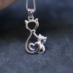 "I am discontinuing this item so grab it while you can. Too many cheap copies out there. Sterling Silver 925 Mother and Kitten Design Sold without a chain. Pendant measures 22mm long x 14mm 9/10\" x 1/2\" This is such a fun pendant!  This was made by carving it in wax and then casting it. This is perfect for a cat lover! This will come in a pretty organza bag, ready to give or open for yourself. Re Images Not all monitors show the same color, the color is what my camera sees. I do not adjust color in my images. Pictures are taken under white light fluorescent bulbs which imitate the sun so this is what the piece will look like in natural daylight or outside on my deck in actual daylight." Cat Pendant, Cameo Necklace, Cat Pendants, Kitten Cat, Delicate Jewelry, Moonstone Pendant, Girlfriend Gift, Chain Pendant, Gorgeous Earrings