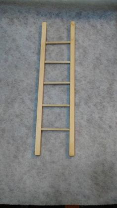 a wooden ladder sitting on top of a carpeted floor