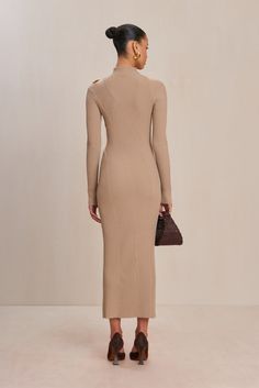 A long-sleeve ribbed knit maxi dress with a mock neck and left shoulder cut out detail. — Maxi length — Ribbed knit — Left cutout shoulder detail — Mock neck Icon Clothing, Evening Flats, Knit Maxi Dress, Sandal Platform, Swimming Bag, Candle Collection, Shoulder Cut, Maxi Knit Dress, Fall Shopping