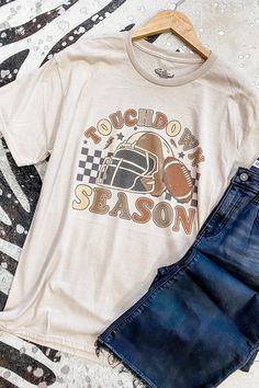 Get ready for touchdown season with our Checkered Football Season Graphic Tee! This retro-inspired tee features a bold football graphic and checkered design, perfect for showing off your love for the game! Add some sporty and nostalgic vibes to your wardrobe with this must-have tee. 52% cotton, 48% polyester round neckline unisex fit Southern Roots Boutique112 W Main St Paragould, AR *Please allow 5-7 business days processing time for this item to be shipped/picked up. Graphic Print Top For Sports Season, Graphic Print Tops For Game Day, Football Season Fan Apparel Tops With Graphic Print, Graphic Print Tops For Game Day And Sports Season, Game Day Graphic Print Top For Sports Season, Graphic Print Tops For Football Season Game Day, Football Season Fan Gear Graphic Top, Graphic Print Top For Game Day Football Season, Team Spirit Football Season Graphic T-shirt