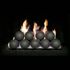 a bunch of balls sitting on top of a fire