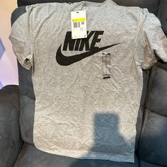 Tag Still In Brand New Never Used Nike Gray Tops With Letter Print, Nike Gray Crew Neck Shirt, Nike Gray Tops With Logo Print, Nike Gray Top With Logo Print, Nike Gray Short Sleeve Shirt, Nike Gray Cotton Tops, Gray Logo Print Casual Shirt, Gray Casual Shirt With Logo Print, Casual Gray Shirt With Logo Print