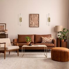 a living room filled with lots of furniture next to a wall mounted painting on the wall