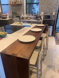 a kitchen island with plates and bowls on it