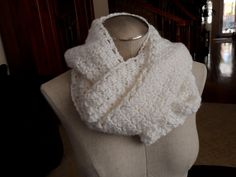 a white knitted scarf on a mannequin