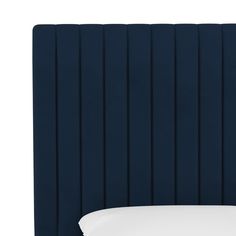 an upholstered headboard with pleated panels and white pillows on the bottom