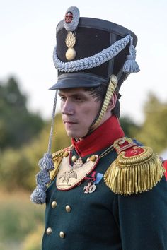 a man in uniform is standing outside