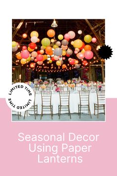 a large room filled with lots of tables covered in white tablecloths and colorful paper lanterns