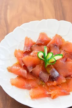 a white plate topped with meat and vegetables