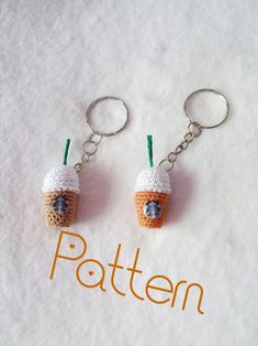 two crocheted keychains with coffee cups on them sitting next to each other