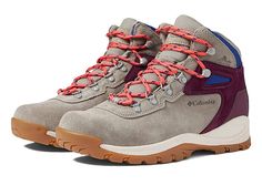 a pair of hiking boots with red and blue laces on the outstep