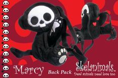 two stuffed animals with black and white skulls on them, one is holding a cord