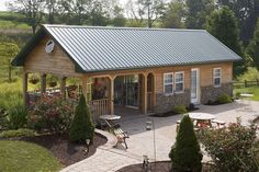 a small wooden house with a metal roof