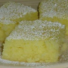 three pieces of cake on a plate with powdered sugar sprinkled on top