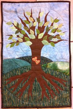 a quilted tree with hearts in the center and leaves on it's branches