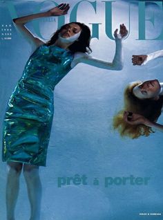 two women in blue dresses on the cover of a magazine, one is upside down