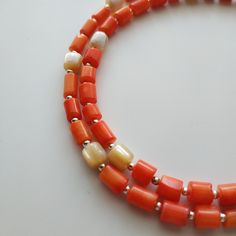 < Lasso coral and mother of pearl necklace > Like 99% of the coral on the market these days, this coral has been dyed. I use bamboo coral which is not endangered or threatened in any way, unlike natural pink or red coral (the production of which is forbidden almost everywhere in the world). Bamboo coral doesn't mean it's not organic. Every bead of it has a distinctive and beautiful coral pattern. My jewelry dyed with high quality paint. It's safe for your health and the paint does not fade Orange Single Strand Spiritual Necklace, Spiritual Orange Necklace Made Of Red Coral, Spiritual Orange Red Coral Necklace, Orange Red Coral Beaded Necklaces Hand-strung, Handmade Orange Double Strand Necklace, Orange Gemstone Beads Necklace In Red Coral, Orange Single Strand Necklace As A Gift, Orange Single Strand Necklace Gift, Orange Single Strand Necklace For Gift