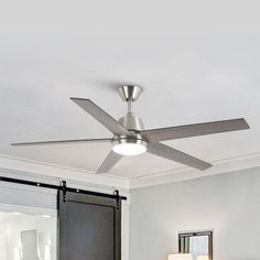 a ceiling fan is mounted on the wall above a bed in a room with white walls