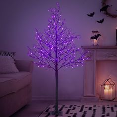 a purple lighted tree next to a fireplace