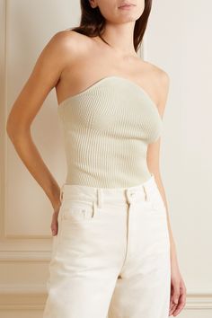 Find KHAITE Jericho Strapless Ribbed-knit Top on Editorialist. Khaite's 'Jericho' top is made from a thick ribbed-knit that provides structure without the need for boning or underwire. Designed for a figure-hugging fit, it has a strapless, convex neckline and contouring darts along the cups. Style yours with leather pants or use it to underpin tailoring. Fitted Fine Knit Cream Top, Beige Stretch Strapless Top, Fitted Strapless Knit Tube Top, Fitted Knit Strapless Tube Top, Fitted Off White Knit Top, Fitted Cream Knit Top, Chic Strapless Knit Tube Top, Chic Strapless Knit Top, Fitted Ribbed Strapless Top