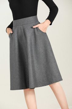 "This winter wool skirt is a classic piece of tailoring that will see you through rain or shine. It is cut with a flattering flared skirt to give you a wonderful shape. The winter skirt is perfect classic styling and ends at the ankle. This is a versatile skirt that you'll wear again and again. DETAILS: * 30% wool, 30% fiber, 40% polyester * fully satiny liner * Two side pockets * Right zip closure * A litter Back elastic, comfortable wear * Plus size skirt * Above knee length * Perfect for Wint Winter Workwear Skirt With Pockets, Winter Full Skirt Bottoms With Pockets, Gray Flared Skirt For Fall, Winter Pencil Skirt With Pockets, Wool Skirt With Pockets For Work, Winter Flared Skirt With Pockets, Solid Color Skirt For Winter Workwear, Wool Workwear Skirt With Pockets, Elegant Fall Skirt With Pockets