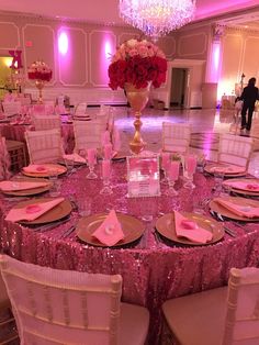 the table is set with pink linens and gold place settings for an elegant event