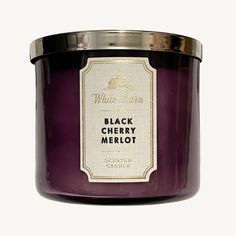 a black cherry merlot candle with a label on the front and back of it