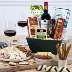 a table with wine, crackers and snacks