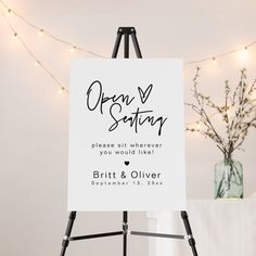 an easel with a sign on it that says guests of events in cursive writing