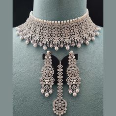 Introducing our Luxe Royal Heritage Collection, where timeless elegance meets modern sophistication. Elevate your ensemble with our Sania Choker Necklace Set, a captivating addition to this regal line. Meticulously designed in the USA and delicately detailed in India, this piece epitomizes opulence and grace. Lightweight and versatile, it effortlessly enhances any look with a touch of regal allure, making it an indispensable part of our Luxe Royal Heritage Collection. Handcrafted, Necklace Set i Ad Necklace Set, Hand Harness, Bangle Ring, Kundan Earrings, Choker Necklace Set, Foot Jewelry, Handcrafted Necklace, Heritage Collection, American Diamond