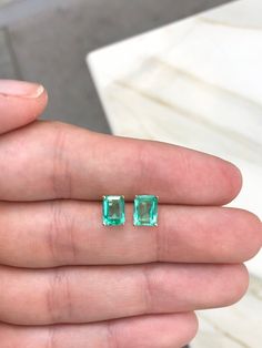 Featured here is a beautiful set of emerald cut Colombian emerald studs in fine 14K yellow gold. Displayed are medium-light green emeralds with excellent transparency, accented by a simple four-prong 14K gold mount, allowing for the emerald to be shown in full view. The earth mined, green Colombian emeralds have a desirable lush green color with excellent qualities. These earrings are ideal for everyday use and are the perfect accessory to any outfit. Total Carat Weight: 2.05cts Setting Style: F Classic Gia Certified Jewelry With Rectangular Stone, Classic Emerald Jewelry With Rectangular Stone, Classic Emerald Cut Birthstone Gemstones, Rectangular Prong Setting Jewelry For May Birthstone, Faceted Emerald Cut Emerald Jewelry, May Birthstone Rectangular Jewelry With Prong Setting, Emerald Cut Emerald Gemstones With Prong Setting, Fine Jewelry Emerald Cut May Birthstone Gemstones, Emerald Cut Emerald Gemstone In Prong Setting