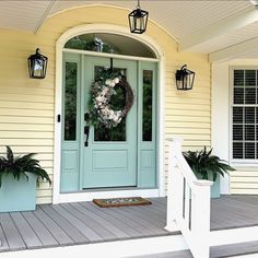 a front porch with a wreath on the door